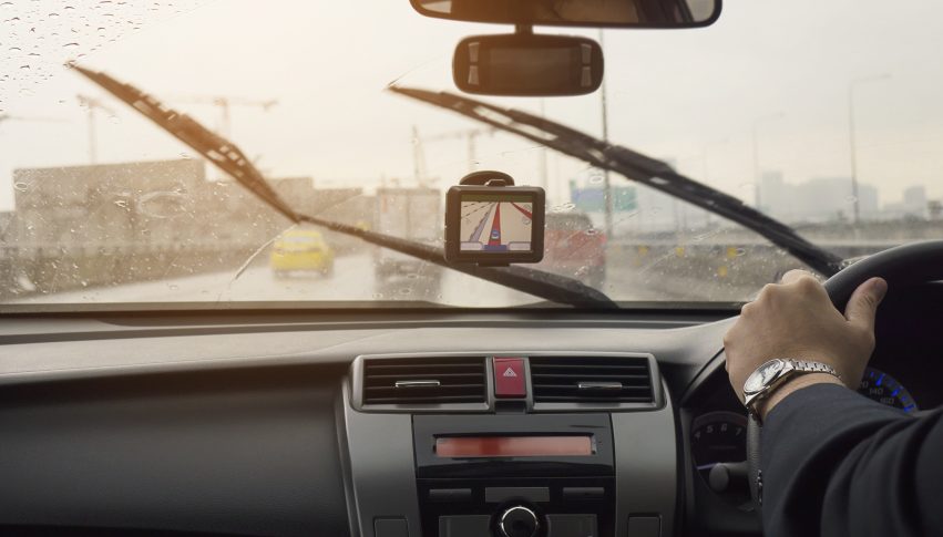 Business man is driving a car in raining day with moving wiper blades